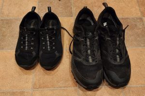 A large pair of shoes on the right and a smaller pair on the left