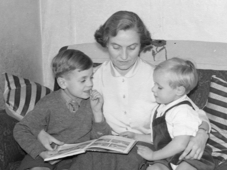 Mother reading to her two sons in 1950s