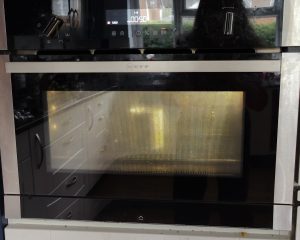 microwave oven with a mug inside and display showing 1000W