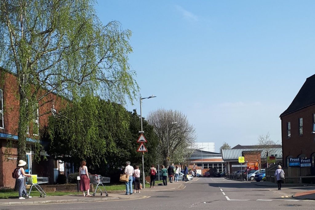 Queue of people outside a supermarket during lockdown for C19 in 2020