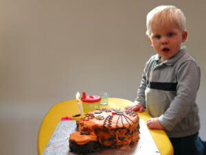 toddler looking at a cake
