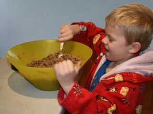 toddler stirring cake mix
