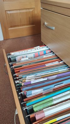 A filing cabinet drawer left open